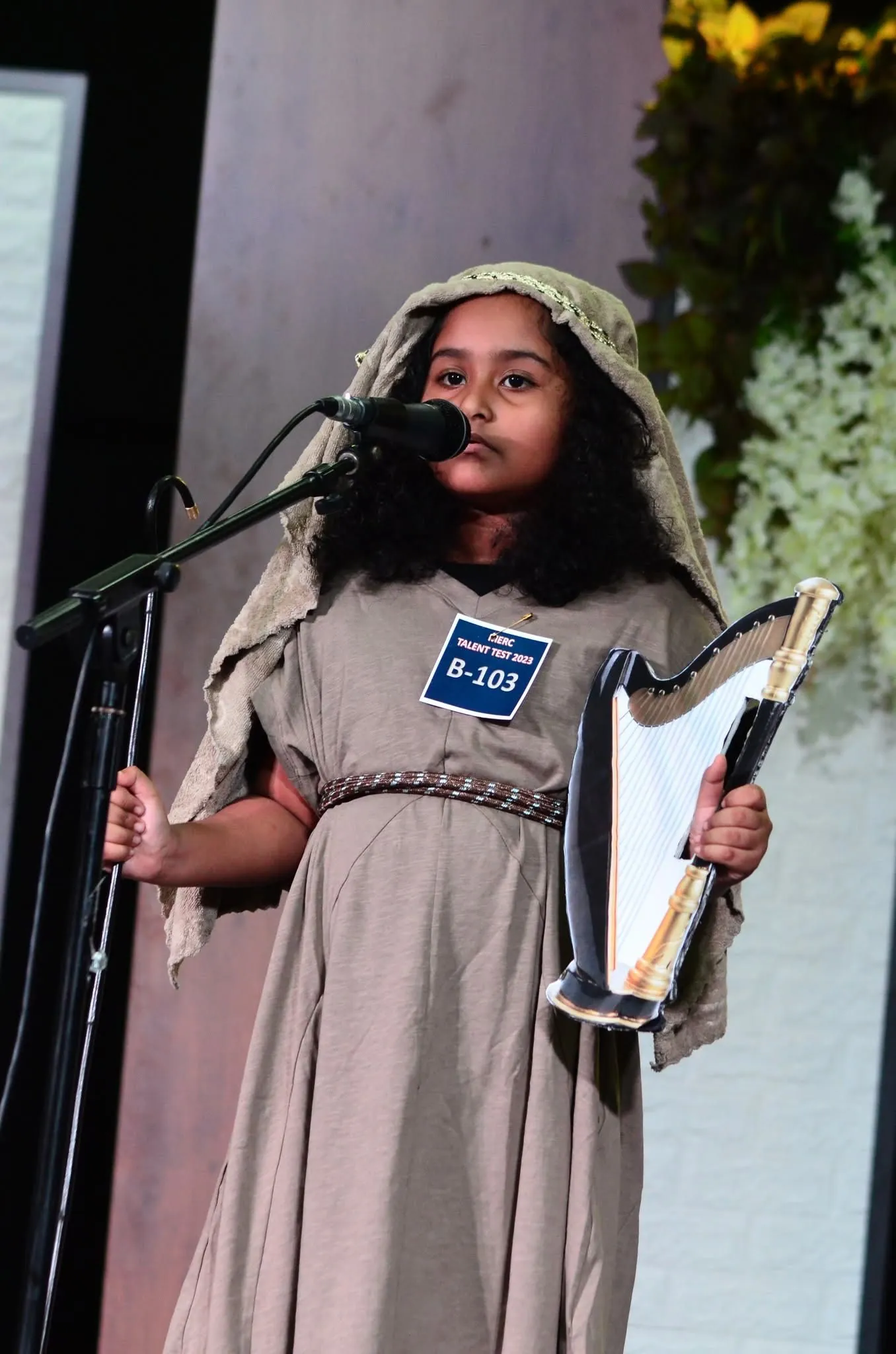 Child dressed as David with a harp at the talent test